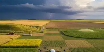 Vast agricultural landscape with smart farming technology and subtle signs of climate impact